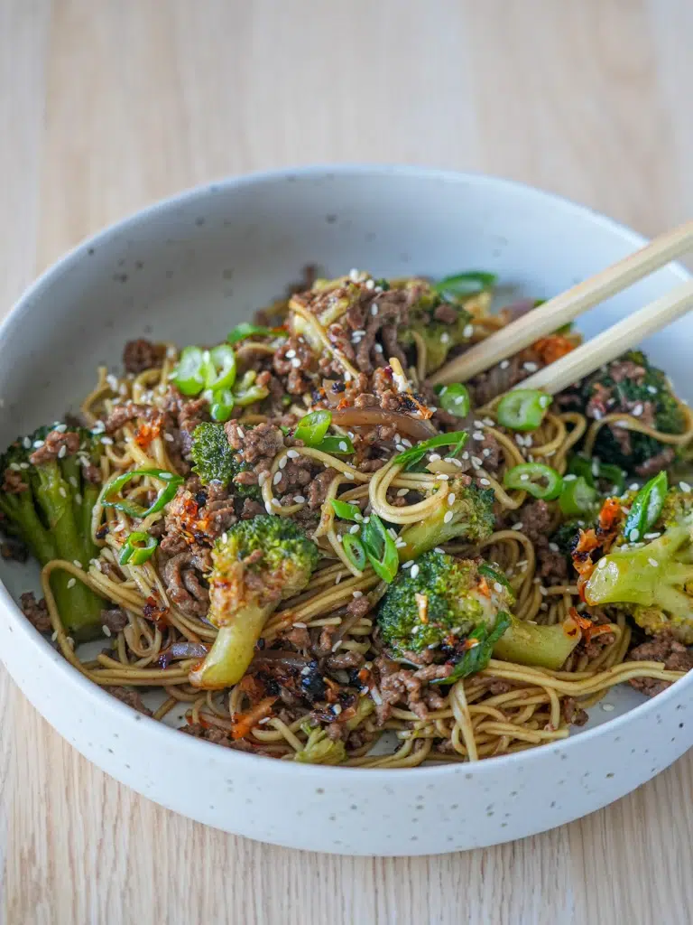 Hearty Beef and Broccoli Noodles presented with chopsticks for serving